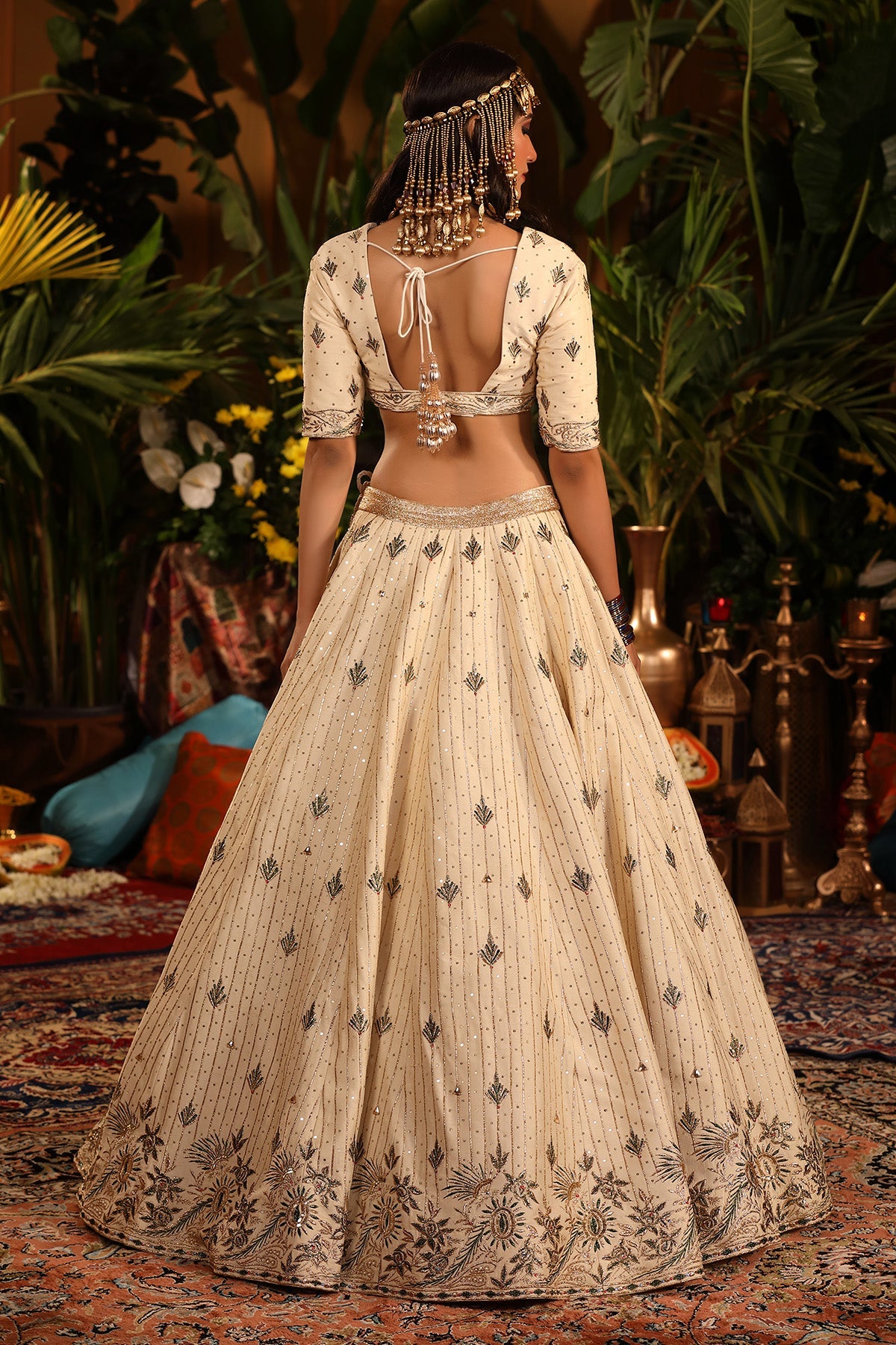 A Ivory Raw Silk Lehenga Adorned With Intricate Gold And Green Embellishments