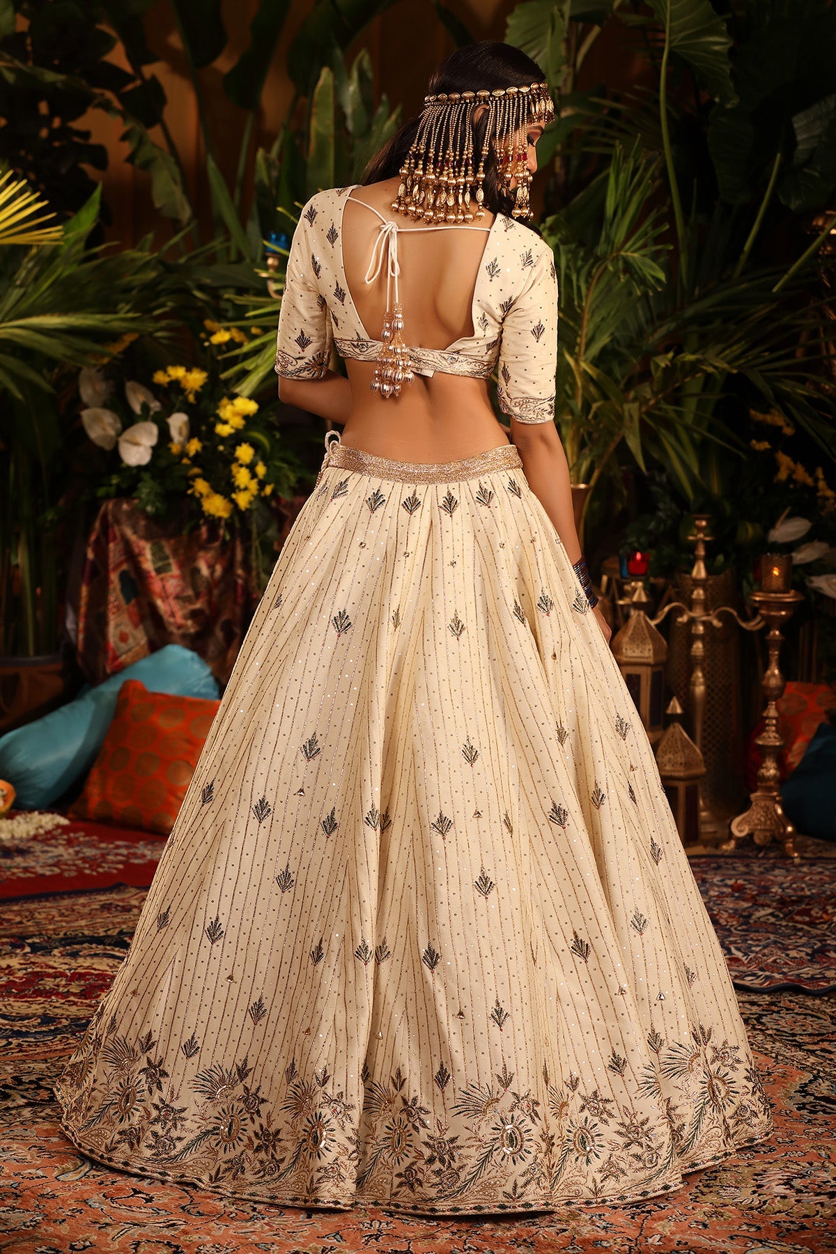 A Ivory Raw Silk Lehenga Adorned With Intricate Gold And Green Embellishments