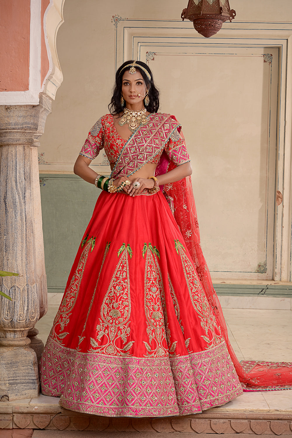 A Red And Rani Pink Silk Lehenga.