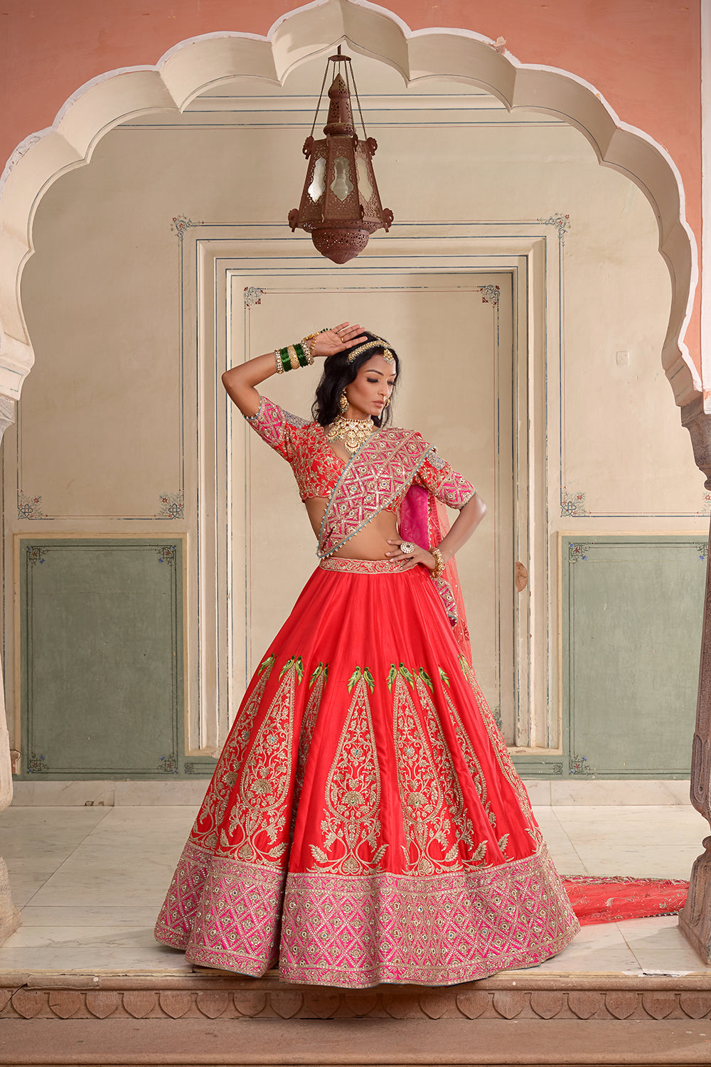 A Red And Rani Pink Silk Lehenga.