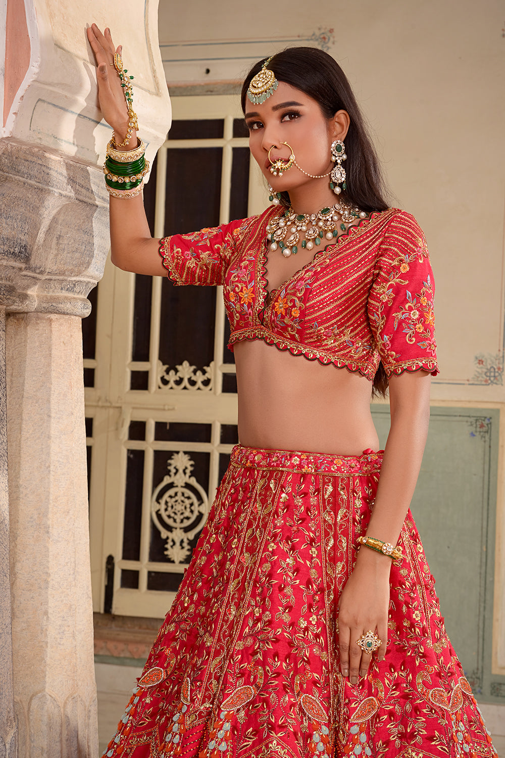 A Red Silk Lehenga, Featuring Peacocks And Floral Motifs